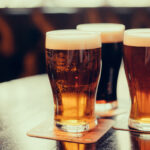 Glasses,Of,Light,And,Dark,Beer,On,A,Pub,Background.